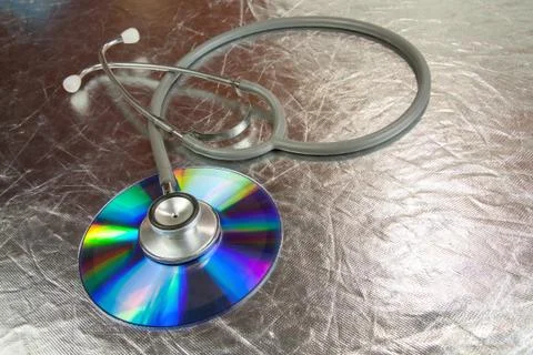 Disk CD and stethoscope Stock Photos