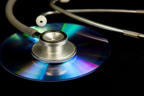 Disk CD and stethoscope Stock Photos