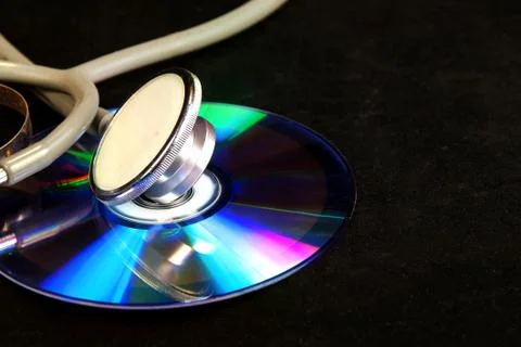 Disk CD and stethoscope Stock Photos