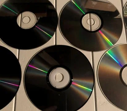 Disk dispersion refraction reflection of light colors texture on white backgr Stock Photos