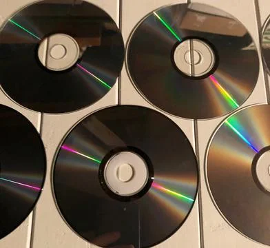 Disk dispersion refraction reflection of light colors texture on white backgr Stock Photos