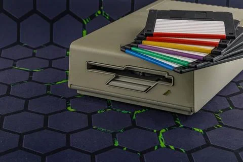 Disk drive from an old computer, colorful 3.5-inch floppy disks Stock Photos