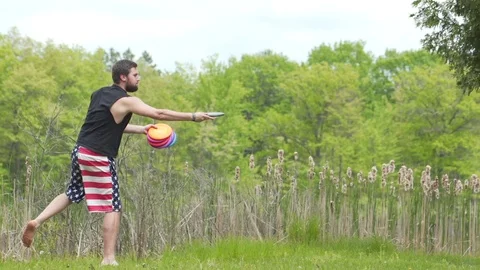 Disk Golf Short Shots College Aged Man with Dogs Stock Footage 87042555