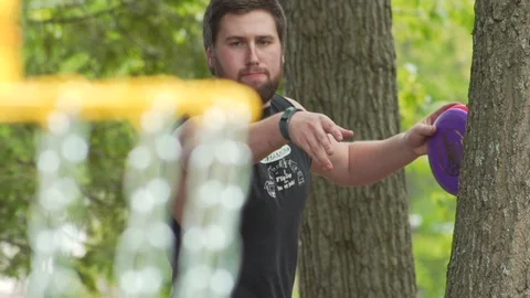 Disk Golfing Shots in Green Forrest Yound Man Closeup Telephoto Lens Stock Footage 87092272