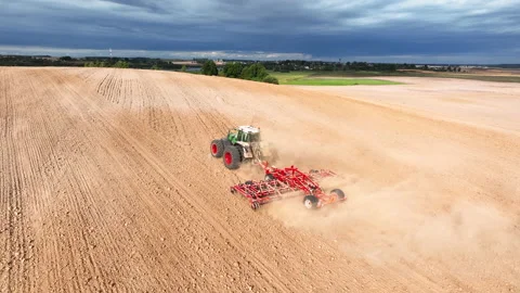 Disk harrow on plowing field. Soil cultivation field use tractor. Stockbeeldmateriaal 212012682