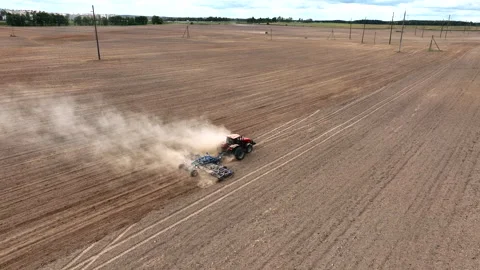 Disk harrow on plowing field. Soil cultivation field use tractor. Video stock 212464476