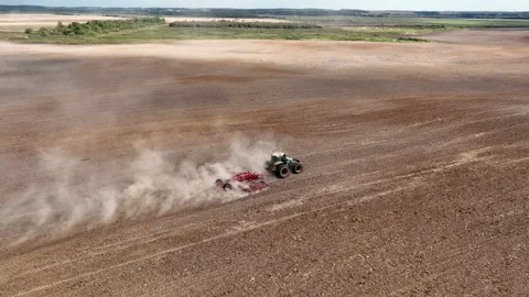Disk harrow on plowing field. Soil cultivation field use tractor. Stock Footage 224314139