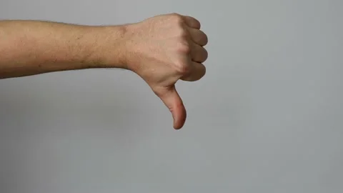 Dislike hand gesture on gray background Stock Footage 238355143