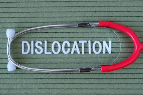Dislocation- text from white letters on  green background with  stethoscope,  Photos