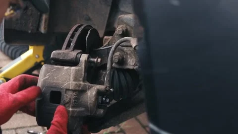 Dislodging seized caliper guide pin with screwdriver and impact force during 動画素材 344537938