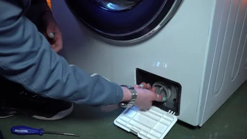 Dismantle the drain filter of the washing machine with blockage. Stock Footage 169606838