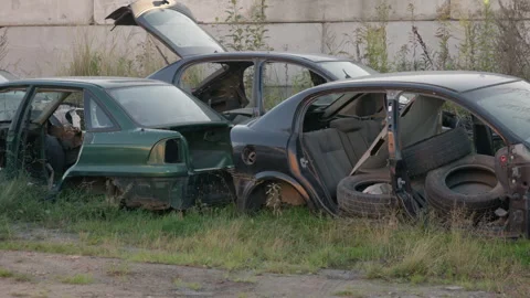 Dismantled car body shells filled with used tires at outdoor junkyard Stock Footage 347968477