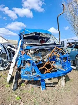 Dismantled turquoise car frame without engine and front bumper at auto salv.. Stock Photos