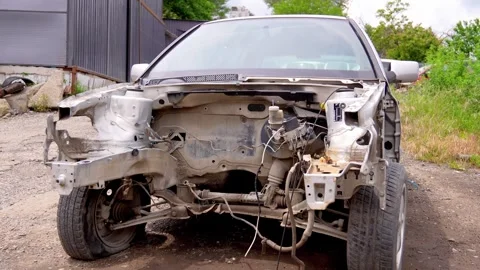Dismantled wrecked car with missing engine in junkyard 스톡 동영상 339166072