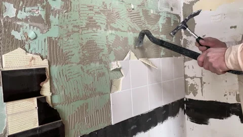 Dismantling ceramic tiles with a chisel and a hammer. Repair work Stock Footage 164170831