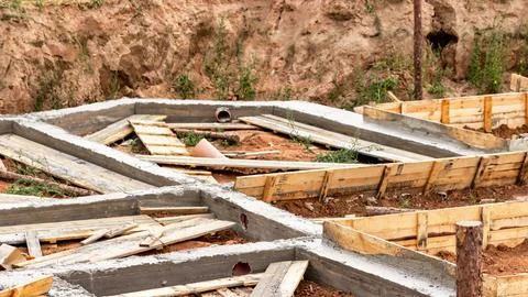 Dismantling the strip foundation formwork at the construction site. Dismantli Stock Photos