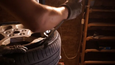 Dismantling of a tire from a disk on a professional machine. Tire mounting. Stock Footage 114630879
