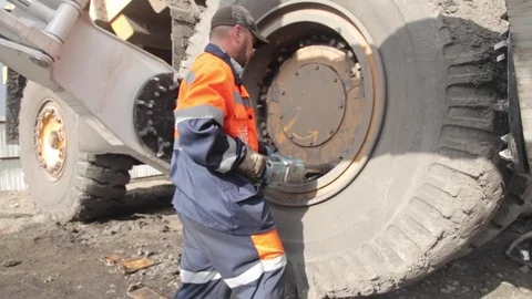 Dismantling of a wheel by old way in the open pit Stock Footage 83624425