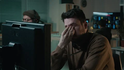 Dismayed Scam Caller Staring at Computer Screen after Failing to Swindle Victim Stock Footage 310266112