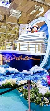 A Disney Cruise display features a model ship with Mickey and Minnie, Stock Photos