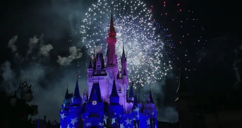 Disney World July 4th Colorful fireworks behind  fairytale turreted castle Stock Footage