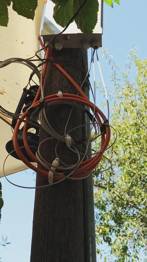 Disorganized tangle of telecom and internet wires, including colorful fiber Stock Footage 341138162