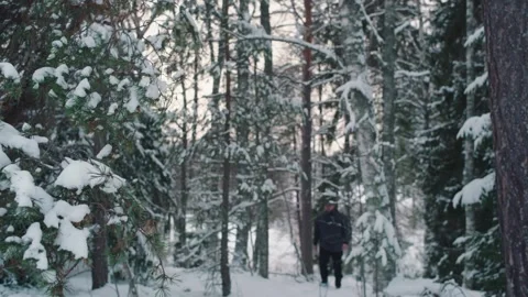 Disoriented and lost man unable to find his way in snowy forest Stock Footage 277007516