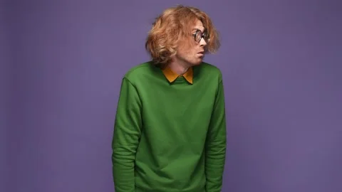 Disoriented guy not see wear specs amazed isolated bright color background Stock Footage 169083321