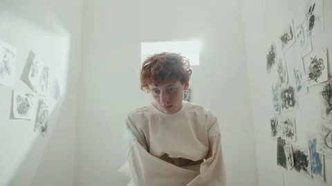 Disoriented Psychiatric Patient in Straitjacket Sitting on Bed in Asylum Stock Footage 313250978