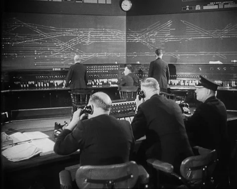 Dispatching control room with workers directing movement of trains, UK 1957 Stock Footage 132323541