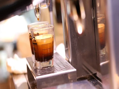 Dispenser grinder machine pouring hot coffee in glass cup measure, cafe restaura Stock Footage 81260374