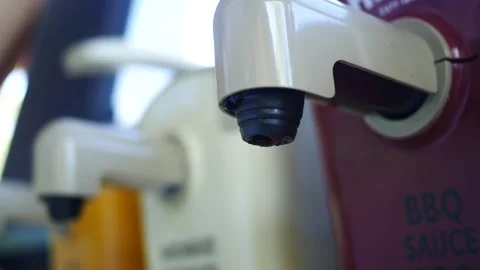 Dispenser Series - Man Uses Buffet Dispenser of Barbeque Sauce at Restaurant Видео 344012529