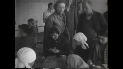 Displaced persons prepare vegetables and cook in kitchen - 1945 Stock Footage 91262687