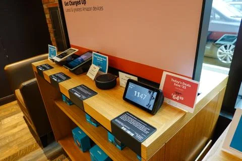 A display of Amazon electronic devices such as, kindle, echo dot, tablet, and Stock Photos