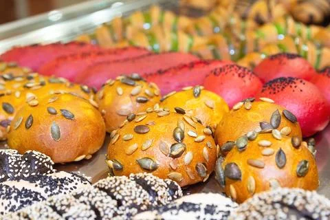 Display of assorted baked goods including flaky pastries and savory rolls i.. Stock Photos