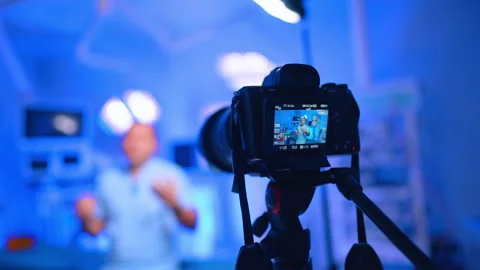 Display of camera with a male medic in blue uniform. Close up. Healthcare blog Stock Footage 334339399