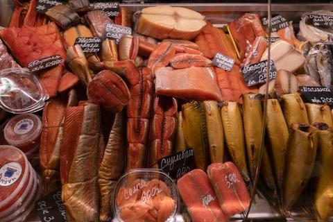 Display case of assorted smoked and salted fish products in a Russian store. Stock Photos