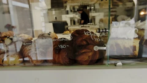 A display case in a coffee shop filled with freshly baked, hot pastries. Stock Footage 267017120