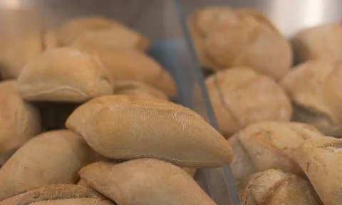 A display case filled with small buns. A store with delicious, crispy, fresh Stock Photos