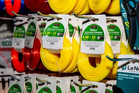 On a display case in a hardware store weigh colored reels with fishing line f Stock Photos
