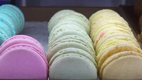 Display case is lined with neat rows of multi-colored macarons. Airy macarons Stock Footage 282610954