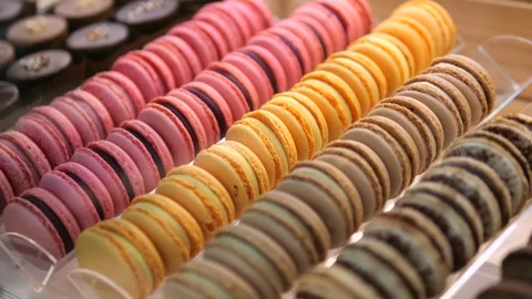 Display case is perfectly lined with neat rows of multi-colored macarons. Airy Stock Footage 276320497