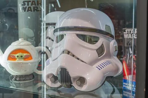 Display case with a Stormtrooper helmet white, black, orange and small robo.. Stock Photos