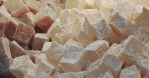 Display case with Turkish delight in powdered sugar. Delicious sweets with nuts Stock Footage 255839405