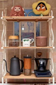 Display of Coffee-Making Tools and Decorative Items in a Cozy Kitchen Nook .. Stock Photos