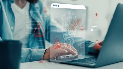 Display of deepfake technology on a laptop screen while a person works at a desk 写真素材