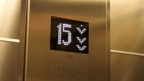 Display of an elevator going down indicating the floor number in white Stock Footage