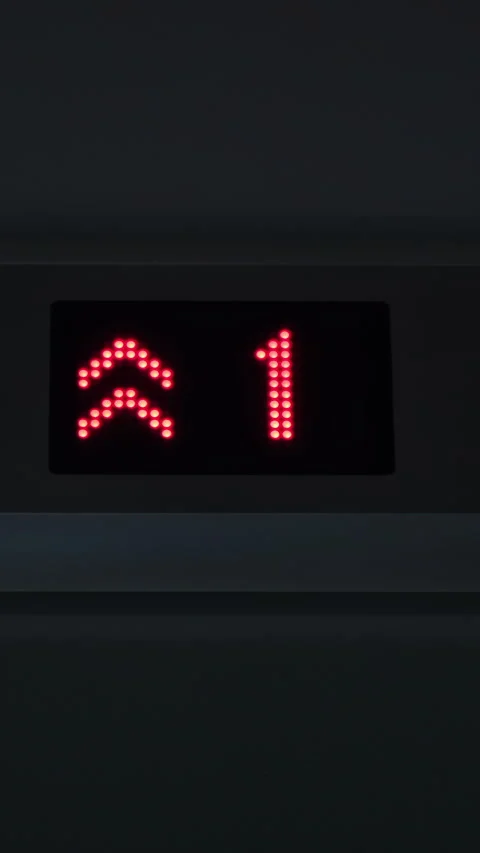 Display of an elevator going up indicating the floor number passing with red Stock Footage 283292530