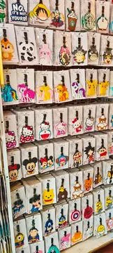 A display features rows of packaged rubber luggage tags Foto stock