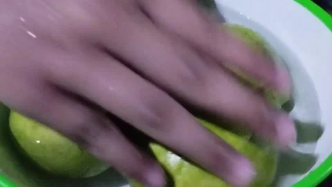 Display of four red crystal guavas soaked in a bowl Stock Footage 229249968
